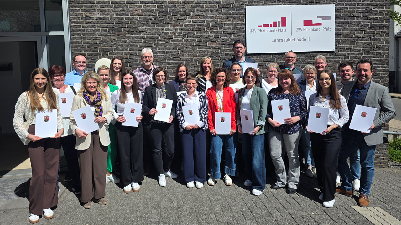 Gruppenfoto der Absolventinnen und Absolventen der Qualifizierung für A 10 mit Urkunden vor dem Lehrsaalgebäude II der HöV Rheinland-Pfalz in Mayen.